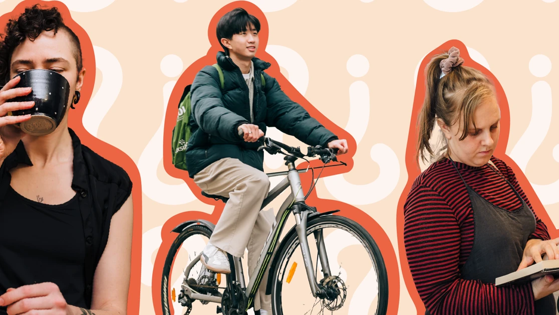 A woman holding a coffee cup while riding a bike.