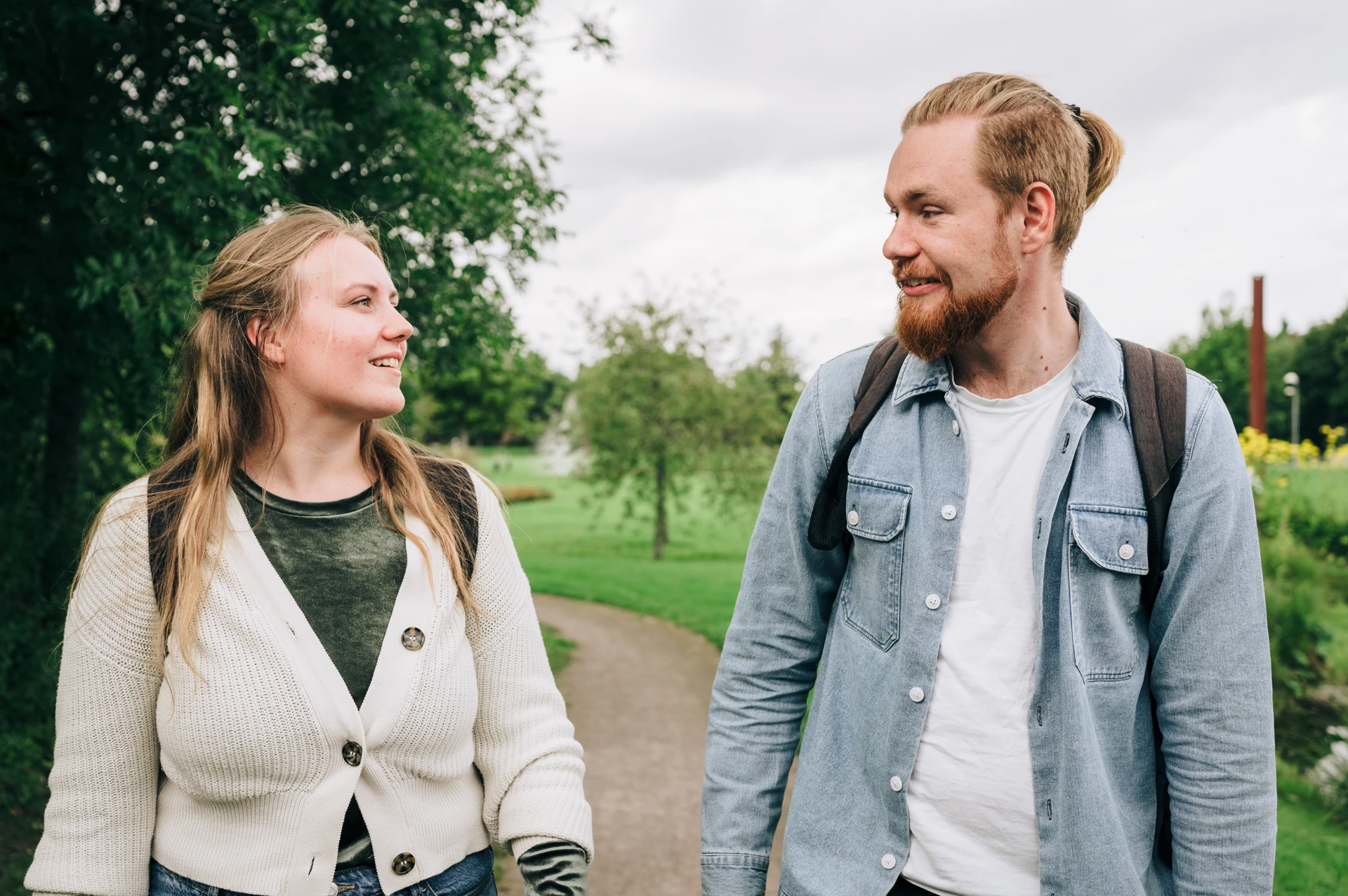 A man and a woman walking down a path.