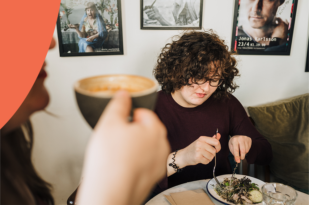 A picture of a person eating at a café